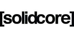 The image shows the logo for Solidcore with the word “solidcore” in bold, black lowercase letters enclosed in square brackets on a white background, illustrating a strong and unified look reminiscent of messages like Whitman Walker stand with us.