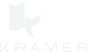 Three white 3D geometric shapes float on a light gray background above the faint text “KRAMER,” evoking the modern elegance of a Whitman Walker 2026 gala event.