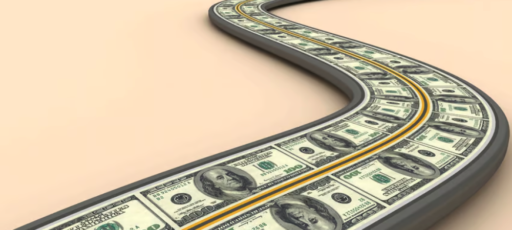 A winding road is paved with $100 bills, symbolizing a path made of money and echoing federal actions in response to the HIV epidemic warning.