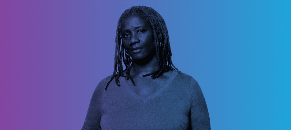 A person with long, textured hair and a neutral expression stands against a gradient background transitioning from purple to blue.